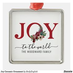 a christmas ornament with the words joy to the world and flowers on it