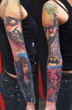 two women with tattoos on their arms and one is wearing a batman mask, the other has