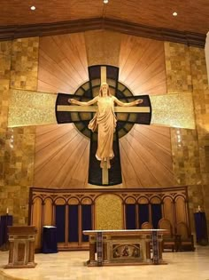 the inside of a church with a large cross