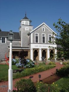 a large house with a clock tower on the top of it's steeple