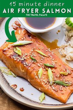 a plate with salmon, rice and sauce on it