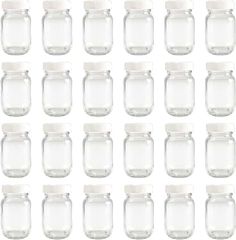 many glass jars with white lids are lined up in rows on a white background photo