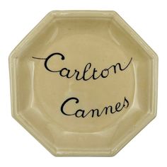 a ceramic plate with the words carlton games written on it's front and side