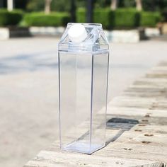 a clear box with a white ball in it sitting on the side of a road