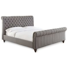 an upholstered bed frame with buttons on the headboard and foot board is shown