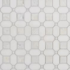 a white tiled wall with hexagonal tiles