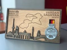 a wooden plaque with a medal on it that says vardan saghyan marathon