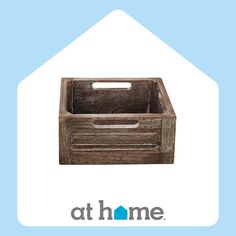 a wooden crate sitting on top of a blue and white background with the words at home above it