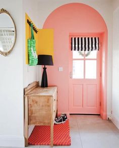 an entryway with pink walls and yellow accents