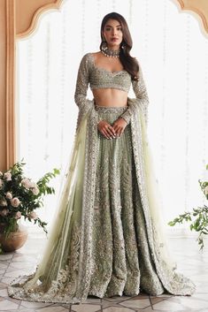 a woman in a green lehenga and crop top