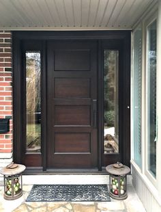 a front door with two lanterns on the side