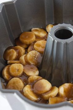 bananas are being cooked in a bundt cake pan with caramel sauce on top