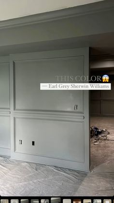 an empty room with gray painted cabinets and white paint on the walls in front of it