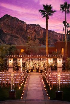 an image of a wedding venue with palm trees and mountains in the background, as seen on instagram