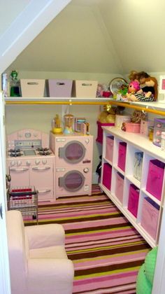 this is a very small room with pink and green accessories on the shelves, including a washer and dryer