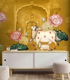 a white cow standing on top of a wooden table next to a flower covered wall