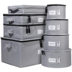 five grey storage containers with labels on them and tags attached to the lids, all stacked up against one another