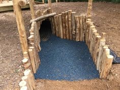 an outdoor play area made out of logs