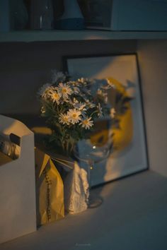 a vase filled with white flowers sitting on top of a table next to a mirror