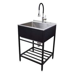 a black sink with two faucets on the side and a metal rack underneath it