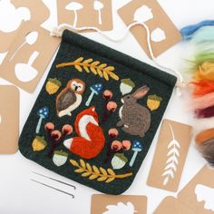 an assortment of crafting materials including felt, scissors and paper cut outs on a white surface