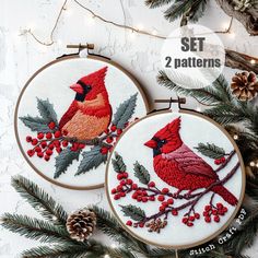 two red birds are sitting on the branch of a christmas tree