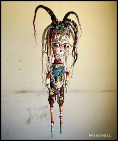 a doll with dreadlocks hanging from a hook