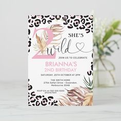 leopard print birthday party card with pink and black flowers on the front, she's wild