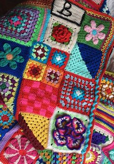 a crocheted blanket with flowers and numbers on it