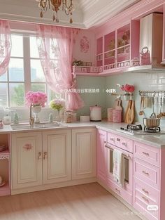 a kitchen with pink cabinets and white counter tops in front of a chandelier