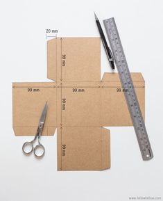 scissors, ruler and cardboard cut out to make a cross