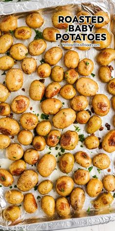 roasted baby potatoes in a baking pan with parsley on top and text overlay that reads roasted baby potatoes