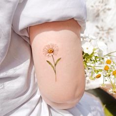 a woman with a flower tattoo on her thigh