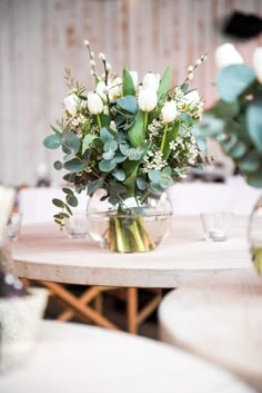 a vase filled with white flowers on top of a table