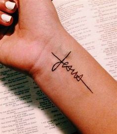 a woman's arm with a tattoo that says jesus on it and the word jesus written in cursive font