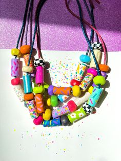 ✿ Bold & unique wearable art Utopic Color Charm Necklace ✿ Made with various shaping techniques ✿ Multicolored & textured handcrafted beads ✿ One of a kind design. Each necklace is distinct from the next ✿ Extremely durable leather cord ✿ Worldwide international shipping Whether you're planning to go to a concert, a festival, a birthday party, a night out with friends, the beach, or the supermarket, delicately handcrafted Utopic Color Charm Necklace adds a unique touch to your outfit! Go To A Concert, Festival Mode, Fun Jewelry, Handmade Beaded Jewelry, Fabric Jewelry, Leather Cord, Festival Fashion, Beaded Necklaces, Clay Earrings