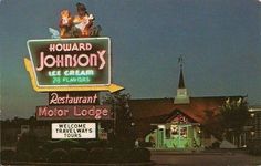 the restaurant sign for howard's is lit up in the dark sky above it