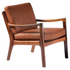 a brown leather chair sitting on top of a wooden frame