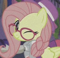 the pinkie is wearing glasses and looking at something