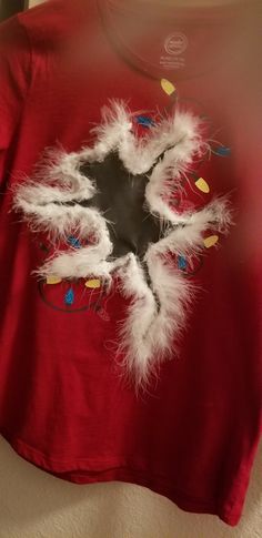 a red shirt with white feathers on it