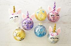 six unicorn ornaments with glitter on them