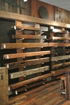 a room that has some wooden pallets on the wall and tables in front of it