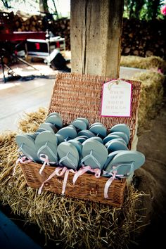 a wicker basket filled with blue plates on top of hay