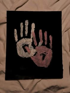 an image of a handprint on a black background with red and white hands in the middle