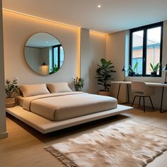 a bedroom with a large bed and round mirror on the wall, along with two desks