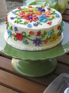 a decorated cake sitting on top of a wooden table