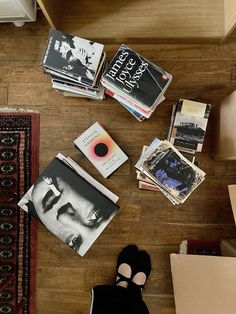 there are many books and magazines on the floor