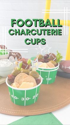 football charcuterie cups are sitting on a tray