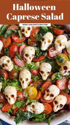 a white bowl filled with pasta and skulls on top of lettuce, tomatoes, and other veggies