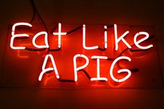 a neon sign that says eat like apis